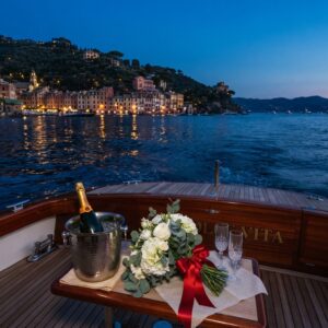 Evening cruise along the illuminated Portofino coastline with champagne on deck – vow renewal cruise in Portofino, Italy – Kiss Me Italy